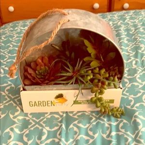 Metal wall planter with artificial succulent